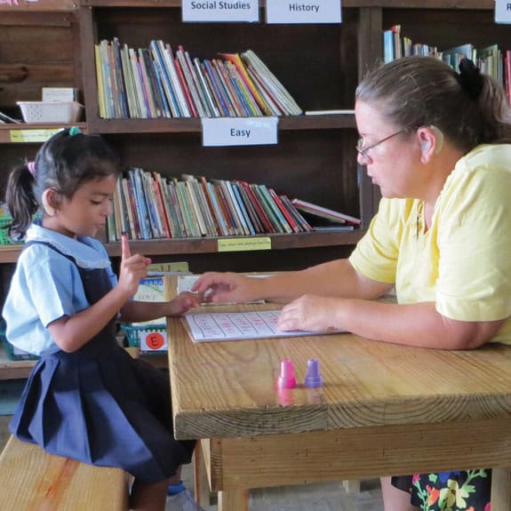 Nancy Marshall with a student in Belize