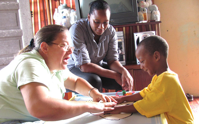 Nancy teaches a young student American Sign Language (ASL). 