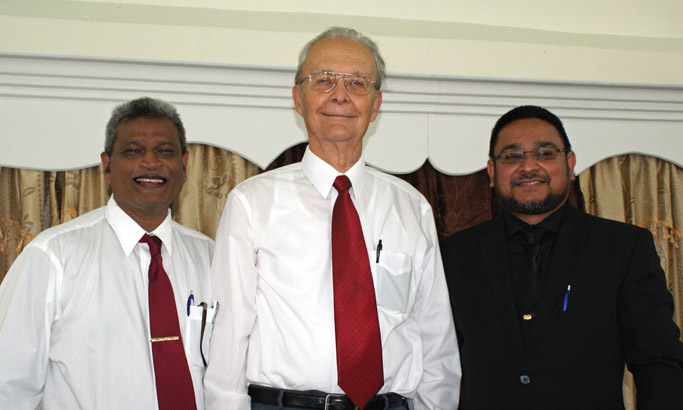 Ganese Gunpath, MCTT overseer (left) and Navin Benny, pastor of Hope Mennonite Church (right) stand beside Paul Kniss, whose spiritual nurture and financial support brought into fruition the Hope Mennonite Church, both in its physical building and in its development as a congregation. Photo by Galen R. Lehman