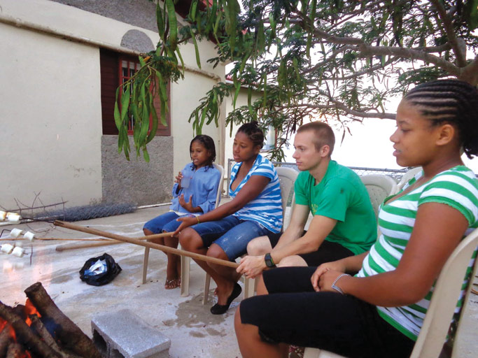 Caleb roasts marshmellows over a fire with youth from the Ridge church in Jamaica, after a Bible study.  Courtesy photo