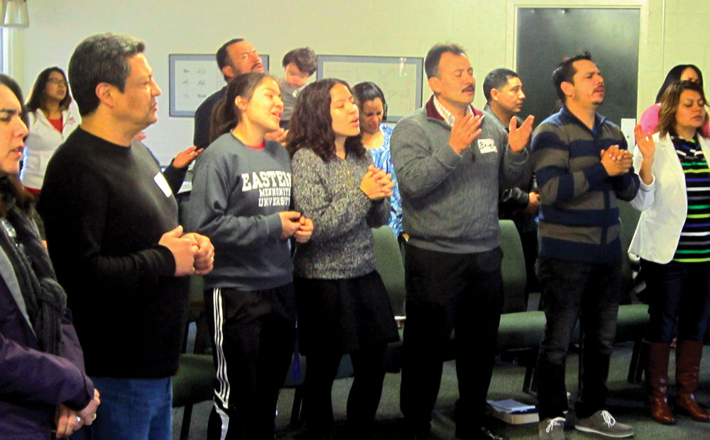 Participants at a Mennonite Hispanic Initative retreat join their voices in praise during a worship service.  Photo courtesy of Marvin Lorenzana