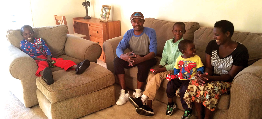 Fred, Cyprien, Moses, Nahiyo, and Consolata, a resettled refugee family from Democratic Republic of Congo, in their Harrisonburg apartment. Photo: Ben Emswiler