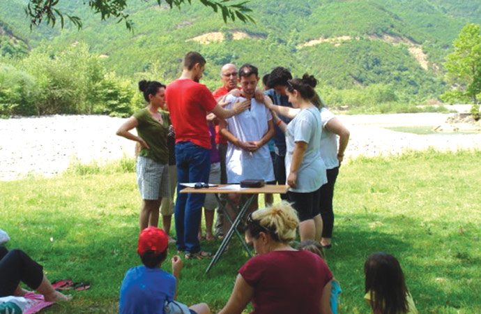 A young man baptized by Rafael Tartari receives a prayer of blessing. “I lost my family, but God gave me a bigger family.”