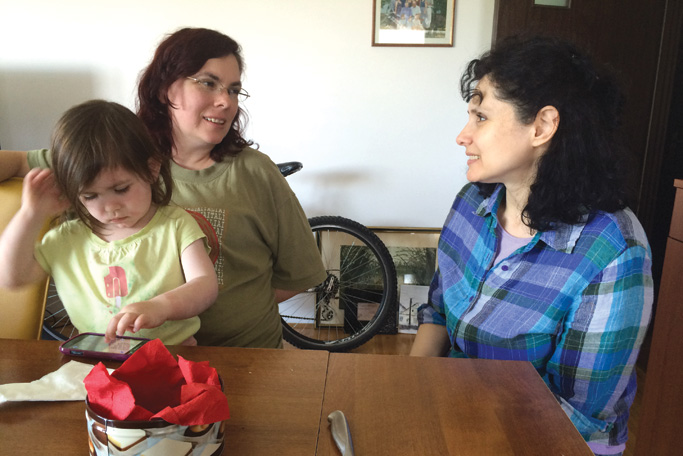 Laura Campbell, the author’s wife, with daughter Esther, talks with Marijana Cizmanski. Serving on the church  leadership team with Vladimir and Marijana, the Campbells use their gifts for discipleship ministry. Photo by Janet Blosser 