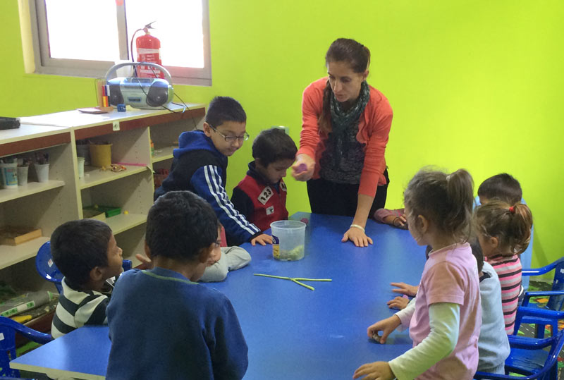 Joshua Center staff member Lily leads an activity time. Geraldo is standing to her right in blue. Courtesy of Janet Blosser