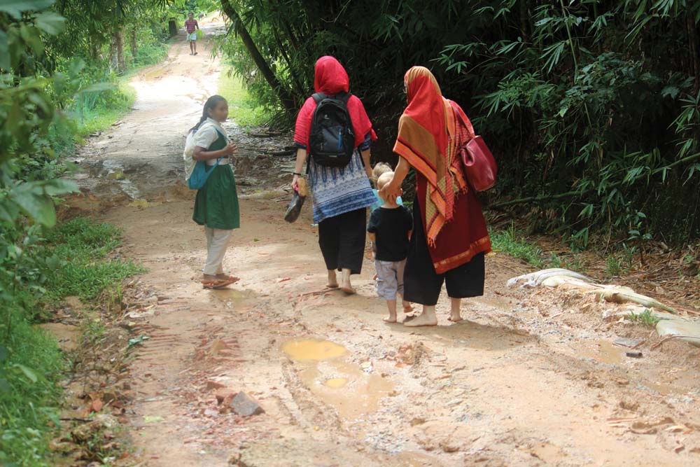 Una strada sterrata fangosa conduce alla casa di una famiglia Rohingya. Sono un popolo apolide in Myanmar che è stato perseguitato, con molti che sono fuggiti nei campi profughi in un paese vicino. Foto per gentile concessione di Osanna