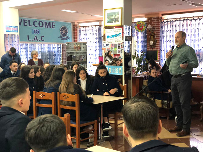 VMMissions worker Dan Hess (top right, with microphone) shares with students about his faith and service in Albania. His wife Mary Hess is  standing second from left in the photo at right.) All Photos courtesy of Jim and Pam Beachy