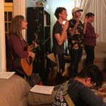 College students worship in the living room of 264 OSH, a hospitality ministry called Eastside College that invites students into a growing relationship with God.