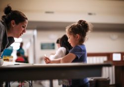 Kids Club volunteer Elizabeth Ochoa interacts with Emily at Park View Mennonite Church. Photo courtesy of Seth Crissman
