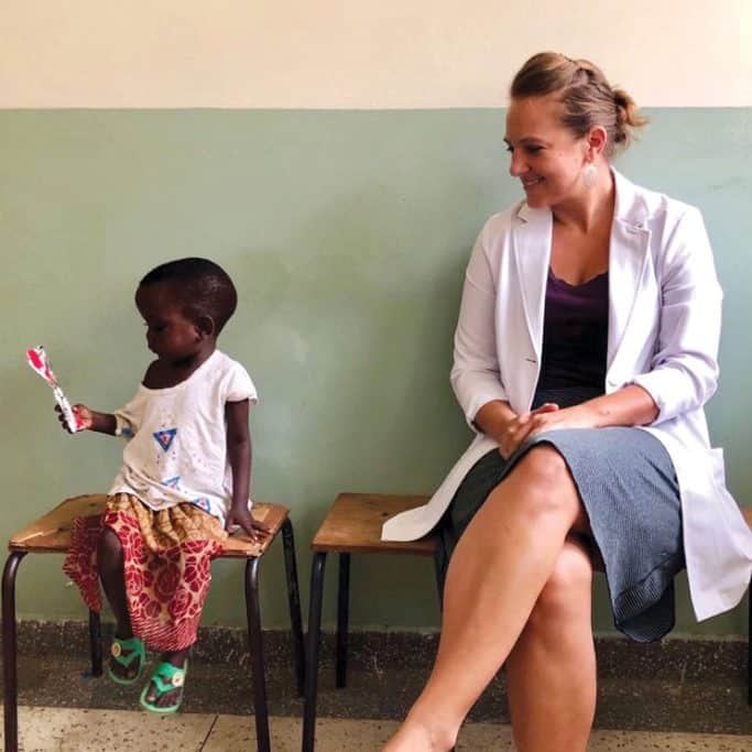 Alisha and a child at the clinic in Uganda