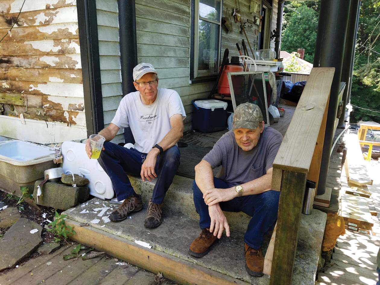 Lee Martin sits with homeowner Billie Joe McPeak during a work break. SWAP staff were improving Billie Joe’s stairs going down to the street level.  July 2020. Photo by Peg Martin