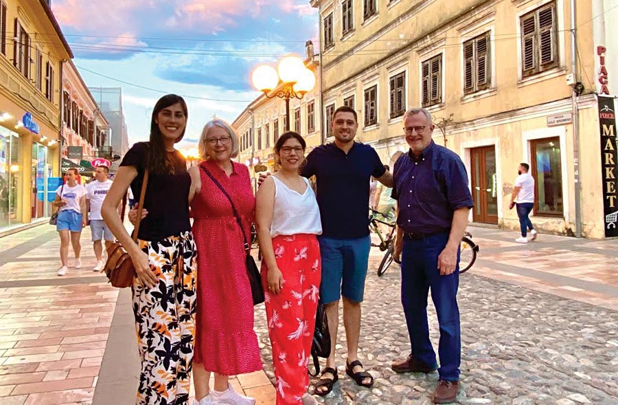Andressa Coutinho (left) serves on the ministry team in Shkodër along with Solange and Rafael Tartari (center). VMMissions staff Tom and Karen Yoder visited them in June. Courtesy photo