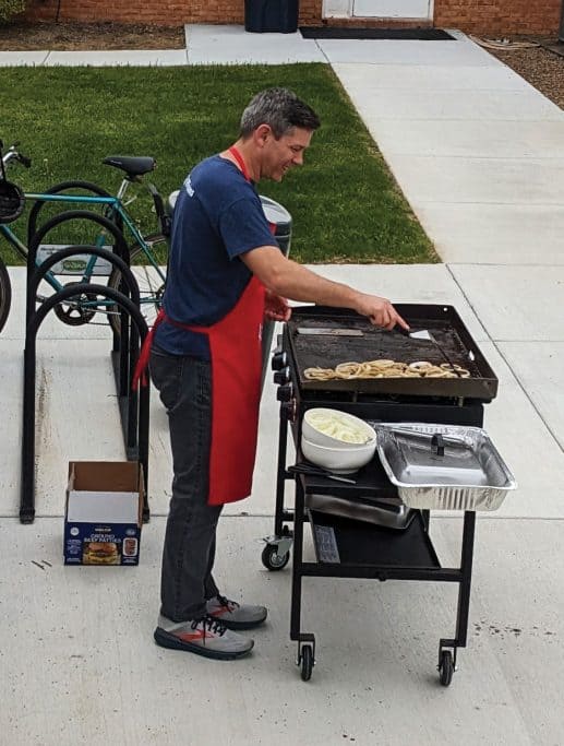 President Aaron Kauffman grills food at the open house on April 17. Photo: Jon Trotter
