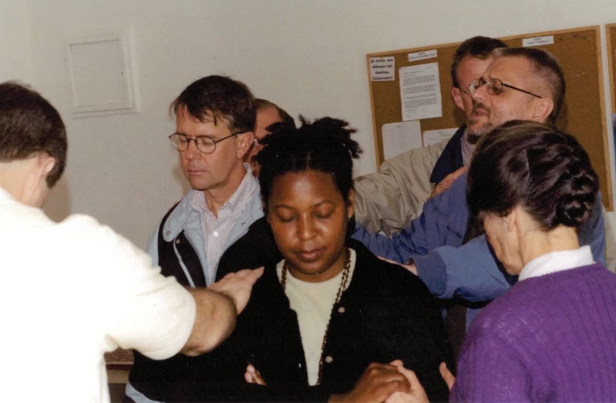 Members of the ministry team in Albania pray for each other, ca. 2000. VMMissions photo