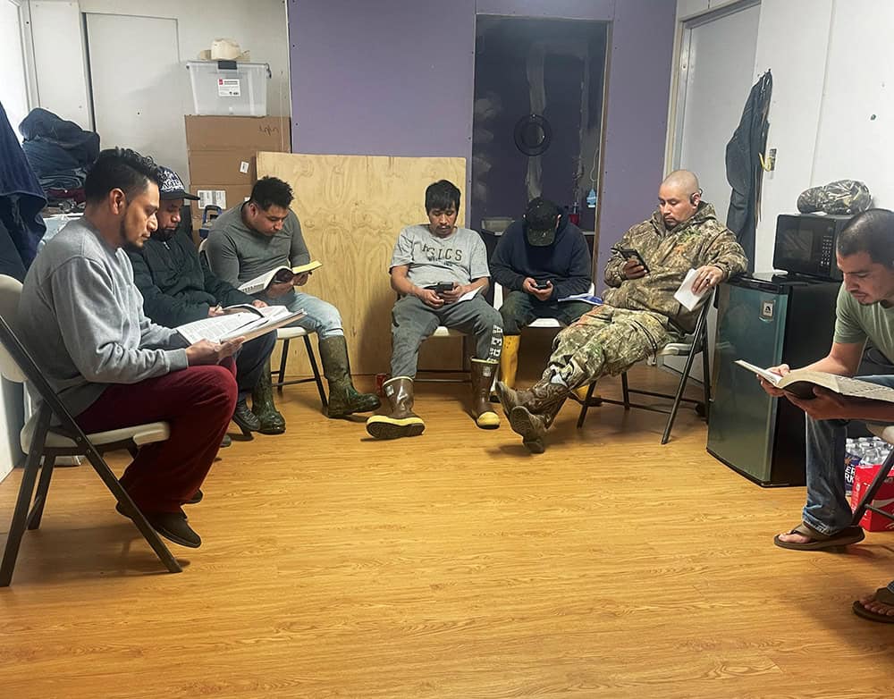 Some of the men working at the Timberville, Va., dairy farm owned by Ben and Risa Yutzy gather for a Bible study. This marketplace ministry is a way for Ben and Risa to live out God’s call to minister to those in need of the gospel. 
Photo courtesy of Ben Yutzy